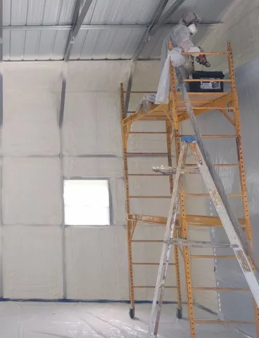 Spray form insulation in a metal building